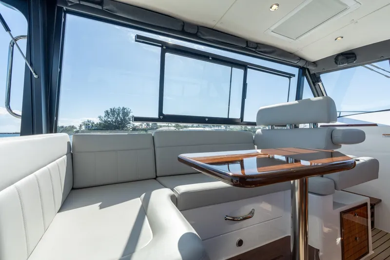 Slide: The Image of Luxurious interior of 2025 MJM 42 yacht with sleek seating and polished wood table. - 38
