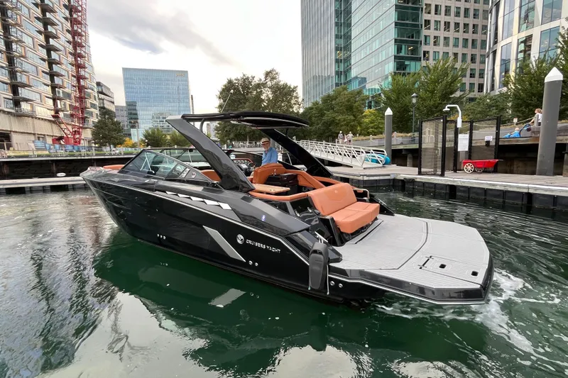 Slide: The Image of 2022 Cruisers Yachts 338 South Beach Edition Bow Rider docked in urban marina. - 12