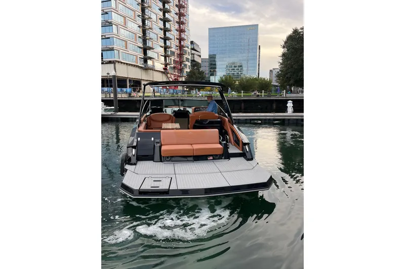 Slide: The Image of 2022 Cruisers Yachts 338 South Beach Edition Bow Rider in urban marina setting. - 13