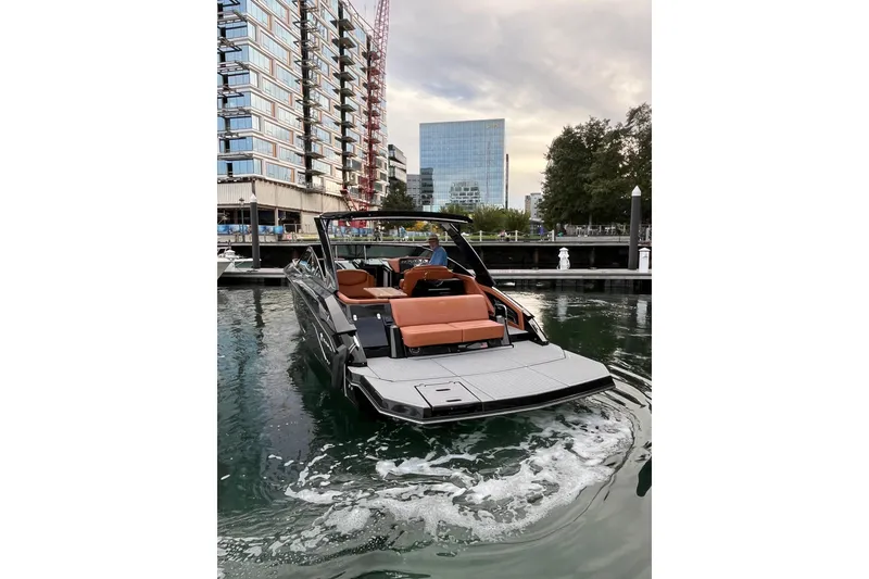 Slide: The Image of 2022 Cruisers Yachts 338 South Beach Edition Bow Rider in urban marina setting. - 14