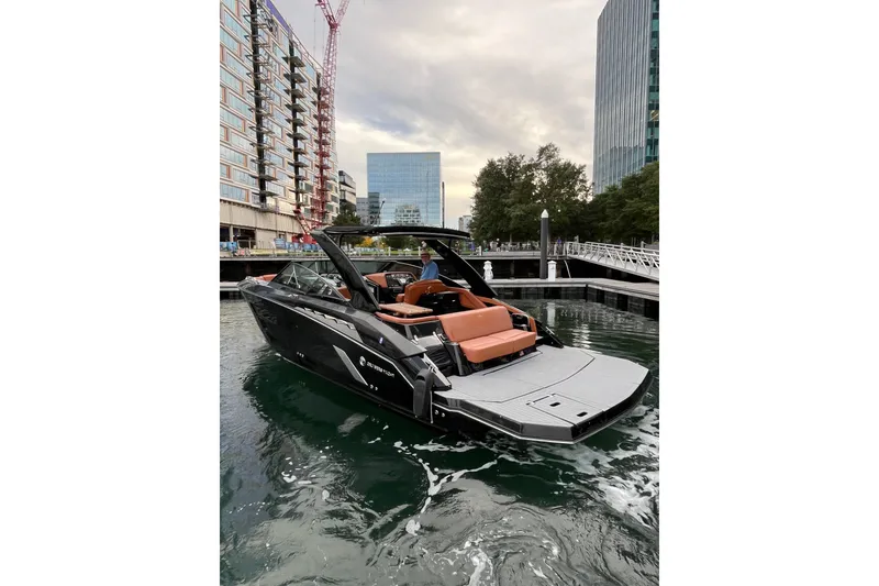 Slide: The Image of 2022 Cruisers Yachts 338 South Beach Edition Bow Rider in urban marina setting. - 15