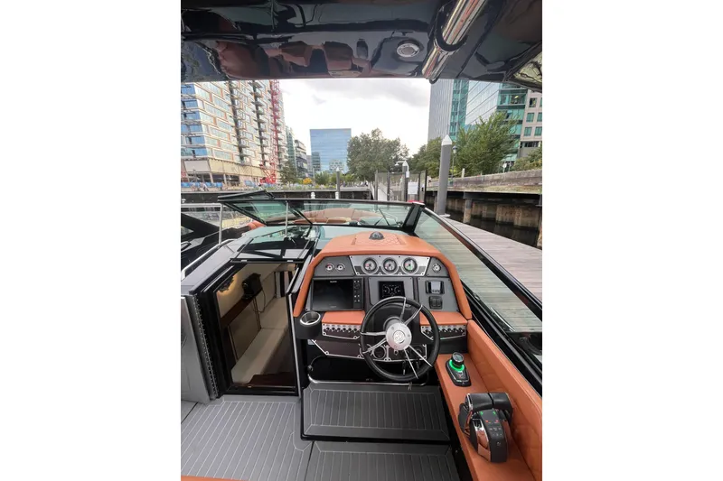 Slide: The Image of 2022 Cruisers Yachts 338 South Beach Edition Bow Rider interior with modern dashboard and steering. - 25