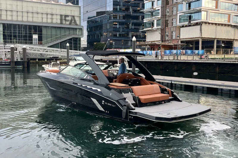 Slide: The Image of 2022 Cruisers Yachts 338 South Beach Edition Bow Rider in urban marina setting. - 3