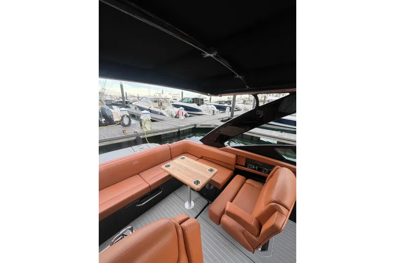 Slide: The Image of 2022 Cruisers Yachts 338 South Beach Edition Bow Rider interior with luxurious seating and table. - 31