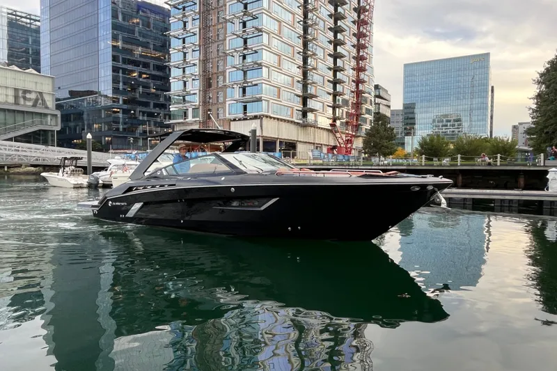 Slide: The Image of 2022 Cruisers Yachts 338 South Beach Edition Bow Rider in urban marina setting. - 4