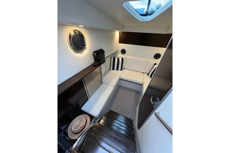 Slide: The Image of Interior of 2022 Cruisers Yachts 338 South Beach Edition Bow Rider, featuring modern seating and decor. - 40