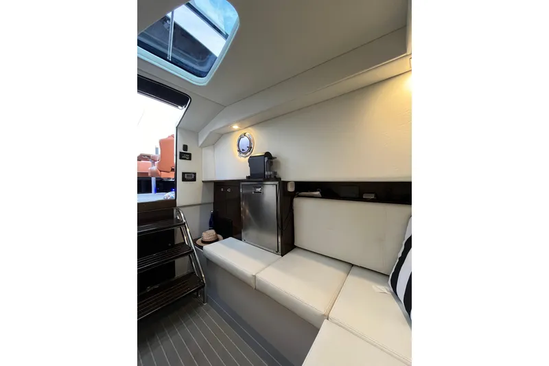 Slide: The Image of Interior of 2022 Cruisers Yachts 338 South Beach Edition Bow Rider, featuring seating and skylight. - 43