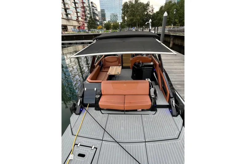 Slide: The Image of 2022 Cruisers Yachts 338 South Beach Edition Bow Rider docked, featuring spacious seating and canopy. - 48