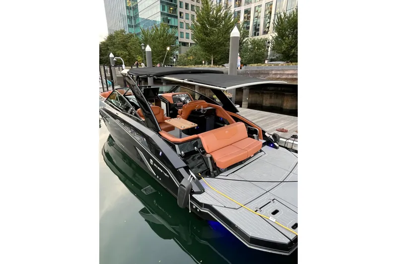 Slide: The Image of 2022 Cruisers Yachts 338 South Beach Edition Bow Rider docked, featuring sleek design and luxury seating. - 49