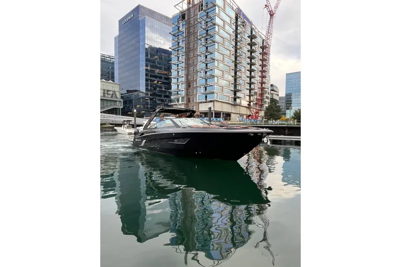 Slide: The Image of 2022 Cruisers Yachts 338 South Beach Edition Bow Rider in urban marina setting. - 11