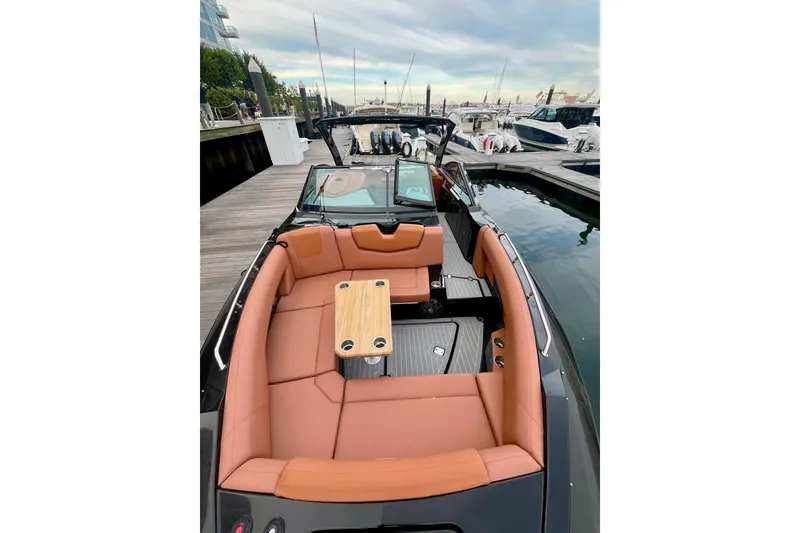 Slide: The Image of 2022 Cruisers Yachts 338 South Beach Edition Bow Rider with luxurious seating and table. - 16