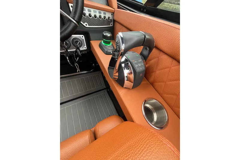 Slide: The Image of 2022 Cruisers Yachts 338 South Beach Edition Bow Rider cockpit with luxurious leather and controls. - 28