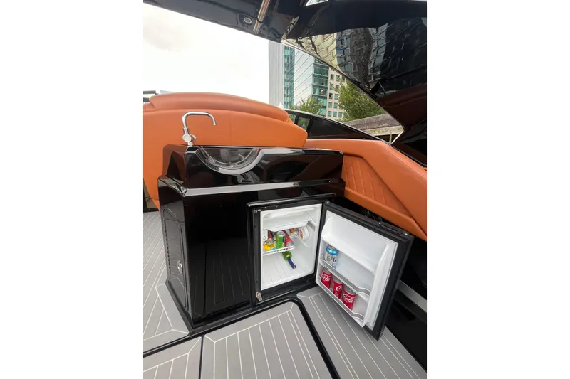 Slide: The Image of 2022 Cruisers Yachts 338 South Beach Edition Bow Rider with open mini fridge and sink. - 30