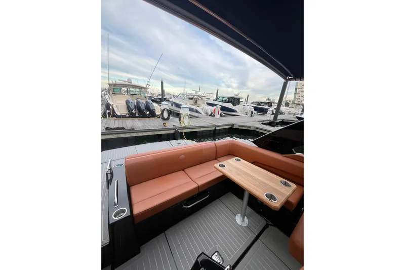 Slide: The Image of 2022 Cruisers Yachts 338 South Beach Edition Bow Rider interior with docked boats in background. - 32