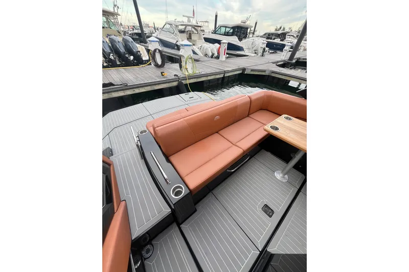 Slide: The Image of 2022 Cruisers Yachts 338 South Beach Edition Bow Rider at marina, featuring luxurious seating. - 33