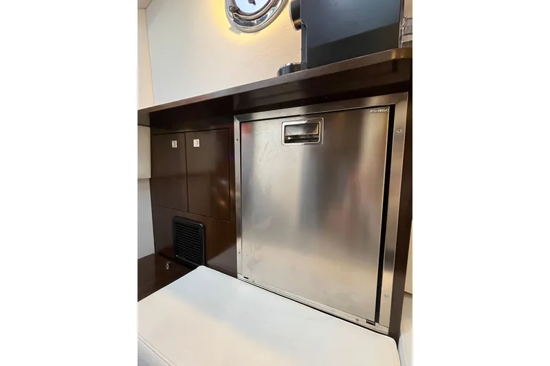 Slide: The Image of 2022 Cruisers Yachts 338 South Beach Edition interior with stainless steel fridge. - 46