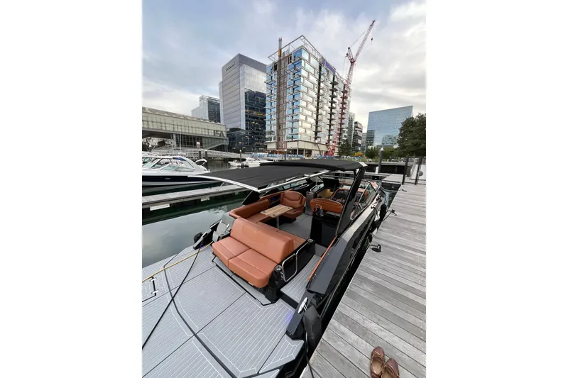 Slide: The Image of 2022 Cruisers Yachts 338 South Beach Edition Bow Rider docked in urban marina. - 52