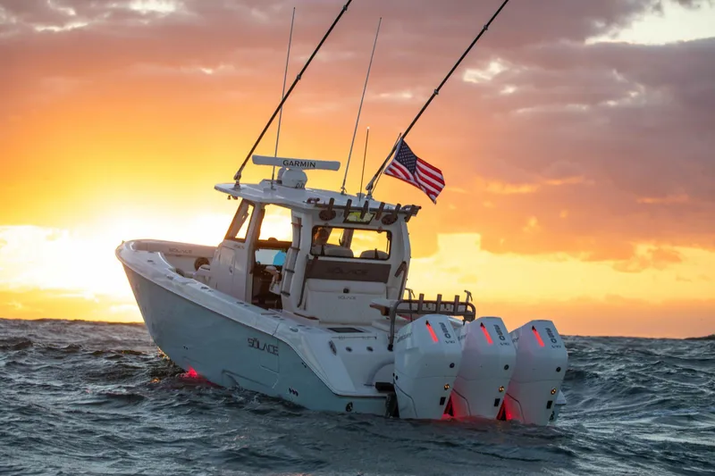 Slide: The Image of 2026 Solace 35 CS boat cruising at sunset with American flag. - 2
