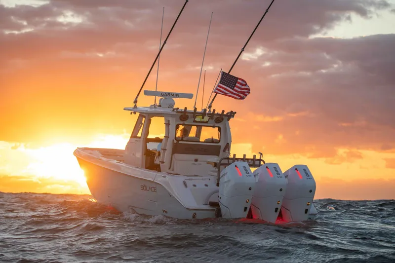 Slide: The Image of 2026 Solace 35 CS boat cruising at sunset with American flag. - 3