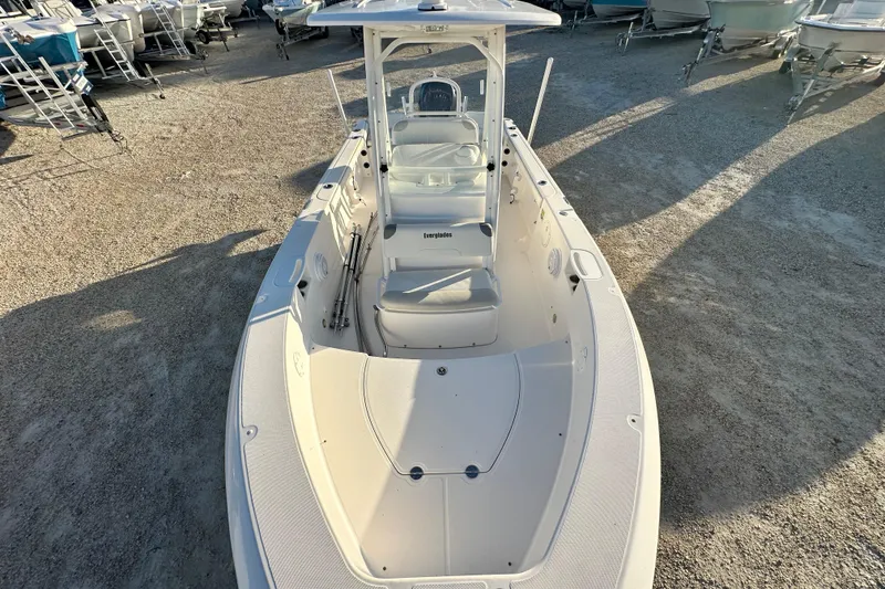 Slide: The Image of 2009 Everglades 230 Center Console boat, white, parked on gravel lot with other boats. - 10