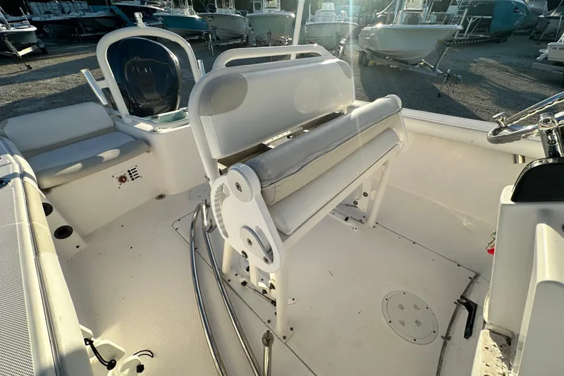 Slide: The Image of 2009 Everglades 230 Center Console boat interior with seating and steering wheel. - 12