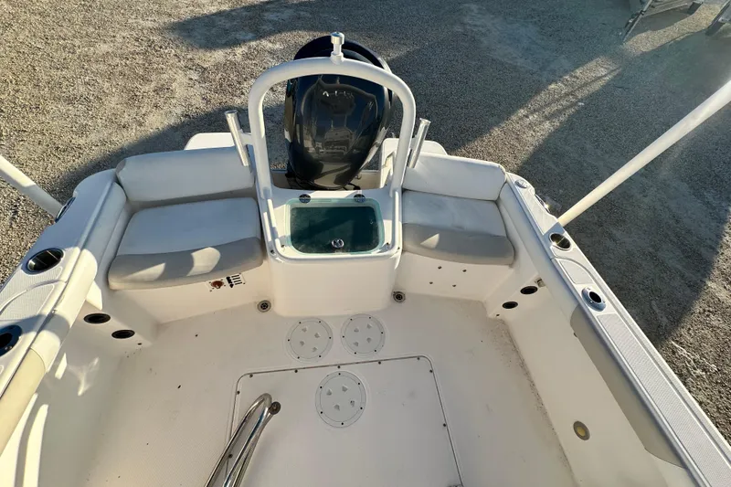 Slide: The Image of 2009 Everglades 230 Center Console boat interior with seating and storage compartments. - 13