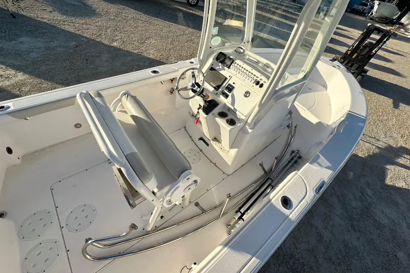 Slide: The Image of 2009 Everglades 230 Center Console boat interior with steering console and seating. - 14