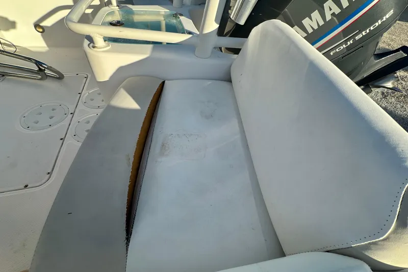 Slide: The Image of 2009 Everglades 230 Center Console boat seat with visible wear and Yamaha engine. - 15