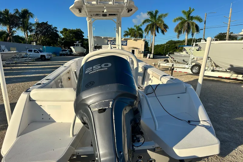 Slide: The Image of 2009 Everglades 230 Center Console boat with 250 horsepower engine, parked outdoors. - 4