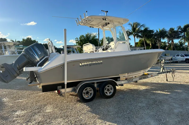 Slide: The Image of 2009 Everglades 230 Center Console boat on trailer, parked outdoors under clear sky. - 5
