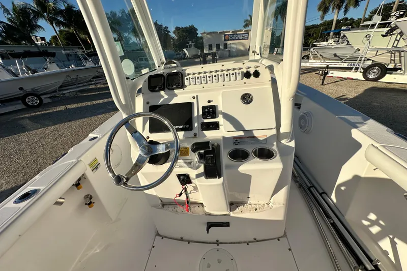 Slide: The Image of 2009 Everglades 230 Center Console boat interior with steering wheel and controls. - 7