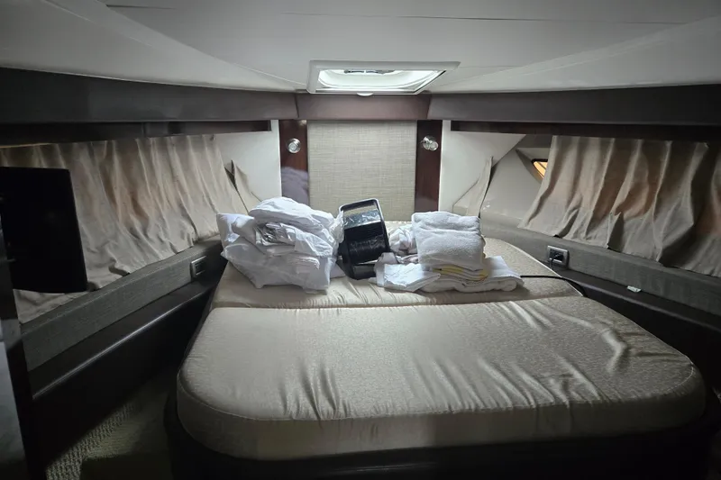 Slide: The Image of Cozy cabin interior of 2016 Sea Ray 400 Fly yacht with bed and linens. - 11