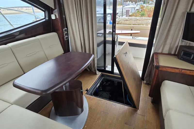 Slide: The Image of Interior of 2016 Sea Ray 400 Fly yacht with open engine hatch and seating area. - 18
