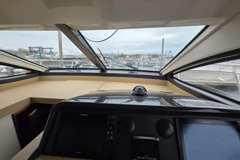 Slide: The Image of Interior view of 2016 Sea Ray 400 Fly yacht cockpit with navigation equipment. - 19