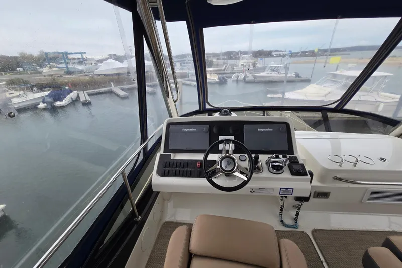 Slide: The Image of Helm of 2016 Sea Ray 400 Fly yacht with dual Raymarine displays at marina. - 2