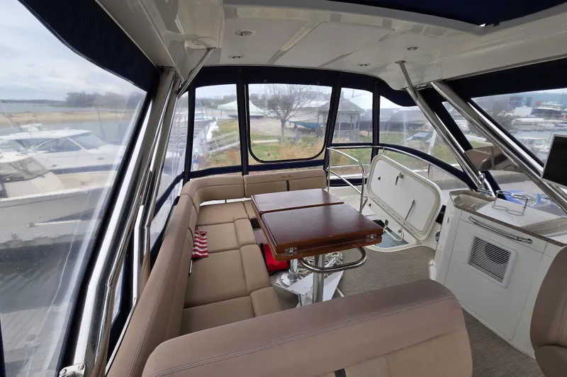Slide: The Image of Interior of 2016 Sea Ray 400 Fly yacht with spacious seating and table. - 23