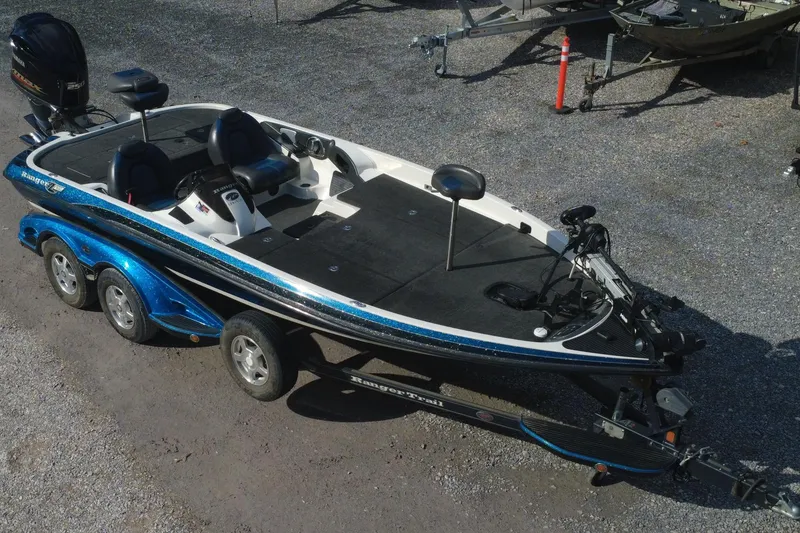 The Image of 2008 Ranger Z520 Comanche Ranger Cup boat on a trailer, parked on gravel. - 1