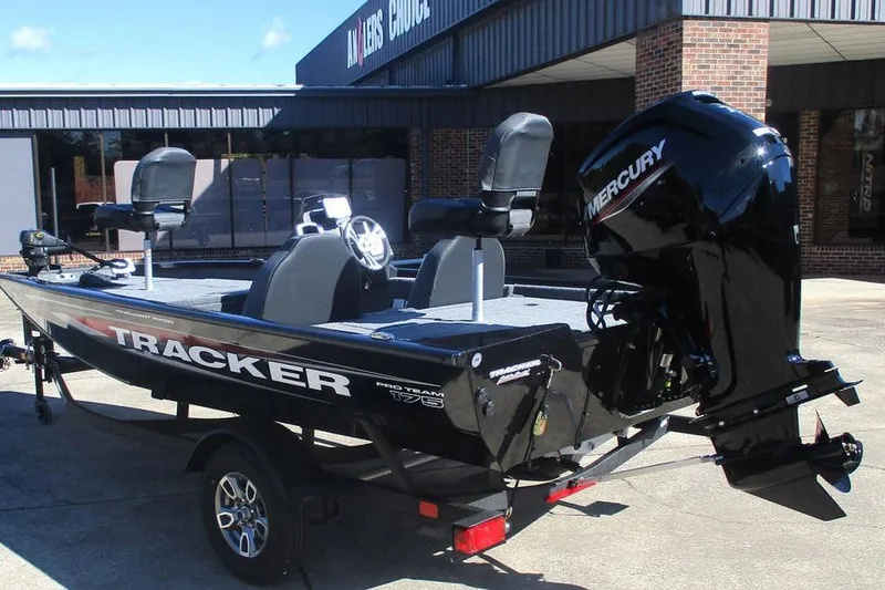 Slide: The Image of 2026 Tracker Pro Team 175 boat with Mercury engine, parked outside a building. - 7