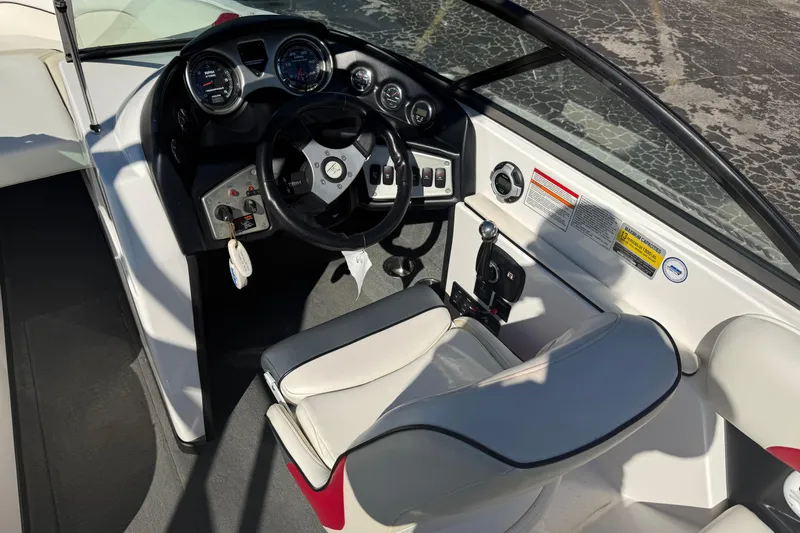Slide: The Image of 2012 Moomba Mobius LSV boat interior with steering wheel and control panel. - 12