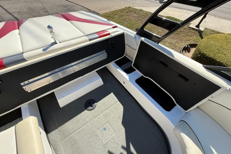 Slide: The Image of 2012 Moomba Mobius LSV interior with open storage compartments and cushioned seating. - 15