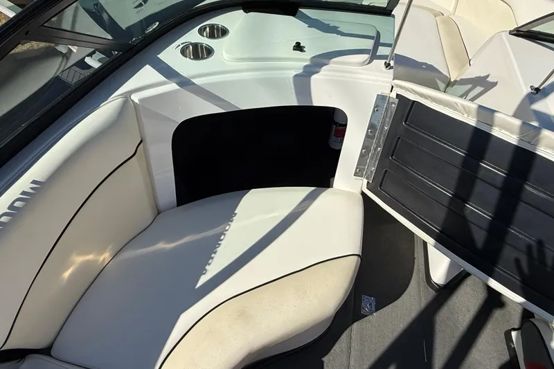 Slide: The Image of 2012 Moomba Mobius LSV boat interior with white seating and storage compartment. - 16