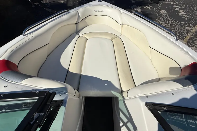 Slide: The Image of 2012 Moomba Mobius LSV boat interior with white cushioned seating and open windshield. - 8