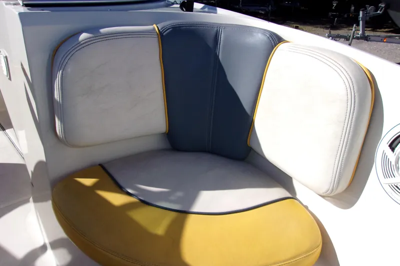 Slide: The Image of 2007 Sea Ray 185 Sport boat seat with yellow, blue, and white upholstery. - 13