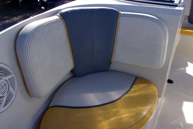 Slide: The Image of 2007 Sea Ray 185 Sport boat interior with blue and yellow cushioned seating. - 14