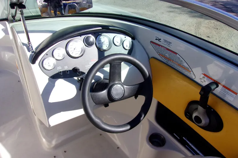 Slide: The Image of 2007 Sea Ray 185 Sport boat dashboard with steering wheel and gauges. - 5