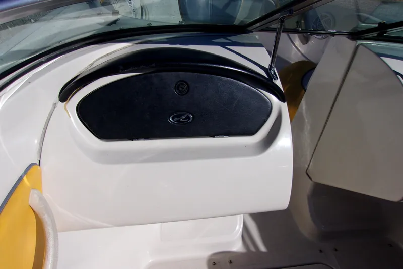 Slide: The Image of 2007 Sea Ray 185 Sport boat interior with black dashboard and yellow seating. - 6