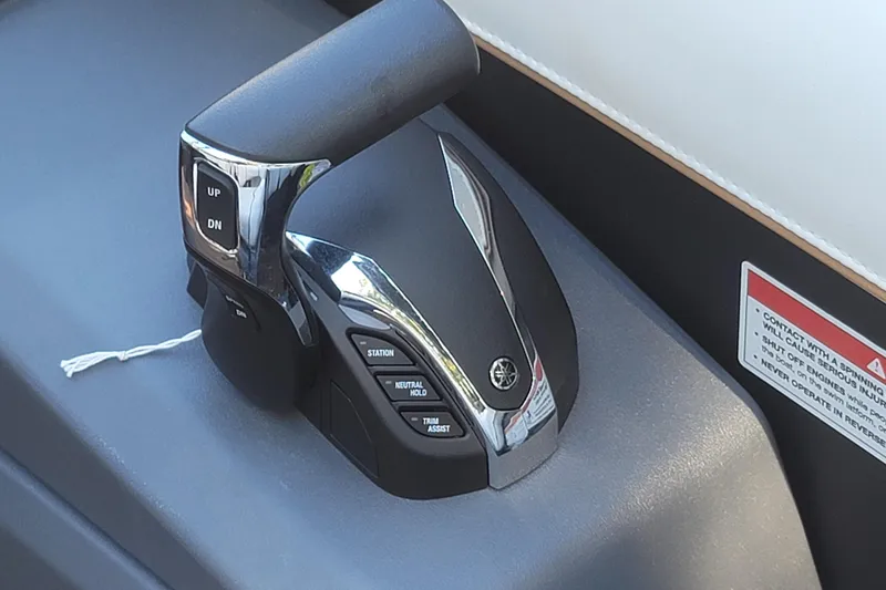 Slide: The Image of Throttle control lever on 2025 Manitou Explore 26 Switchback boat dashboard. - 11