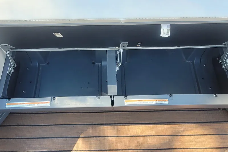 Slide: The Image of Open storage compartment in 2025 Manitou Explore 26 Switchback boat. - 22
