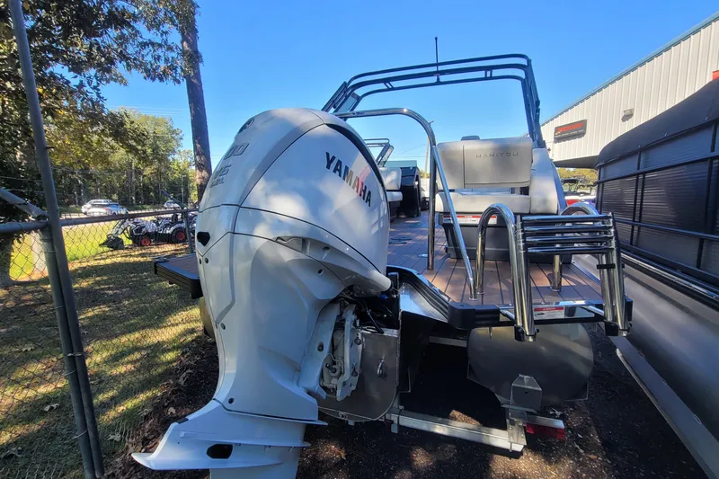 Slide: The Image of 2025 Manitou Explore 26 Switchback pontoon boat with Yamaha outboard motor. - 25