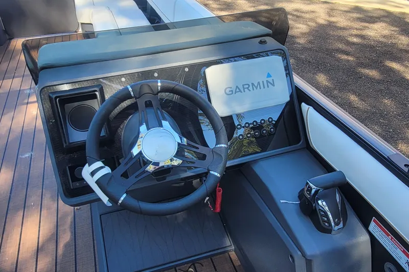 Slide: The Image of 2025 Manitou Explore 26 Switchback boat dashboard with Garmin navigation system. - 8
